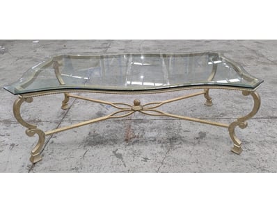 Elegant brass and glass coffee table featuring a s...