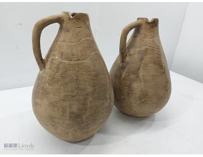 Pair of  terracotta vessels featuring characterist...