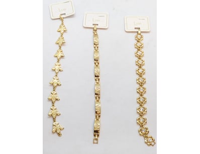 THREE FAUX GOLD NECKLACES WITH FLOWER AND CHAIN MO...