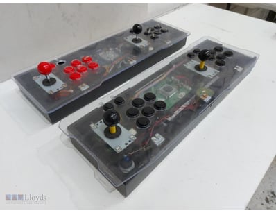 Pair of arcade control panels featuring dual joyst...