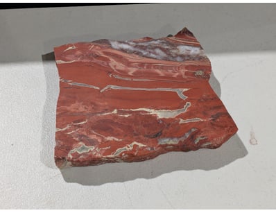 Striking red and cream banded agate specimen featu...