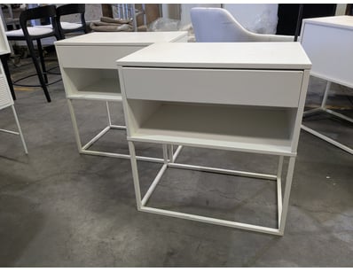 Modern white bedside table featuring a minimalist ...