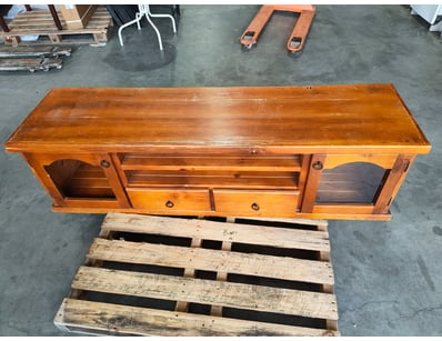 Vintage timber entertainment unit featuring a warm...