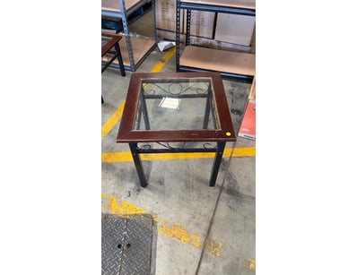 Glass-top side table featuring a dark wood style f...