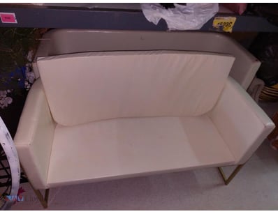 Modern cream upholstered two-seater sofa featuring...
