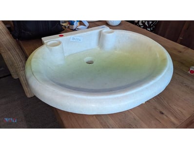Vintage pedestal sink basin in cream-coloured ston...