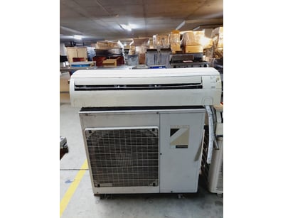 Split-system air conditioning unit featuring a whi...