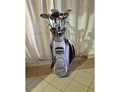 Bag of left handed golf clubs, blue and white fini...