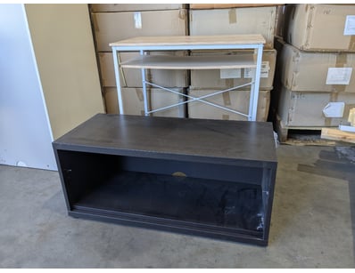 Black storage cabinet with open shelf design. Feat...