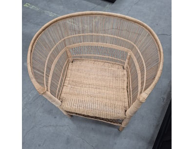 Woven rattan barrel chair featuring a distinctive ...