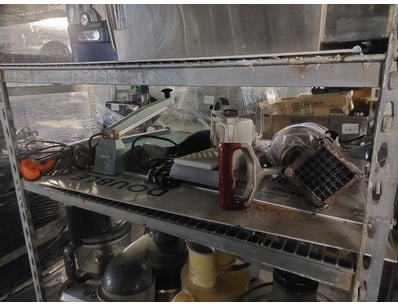 Industrial metal shelving unit containing vintage ...