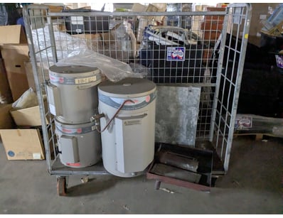 Lot of used electric water heaters featuring Rheem...