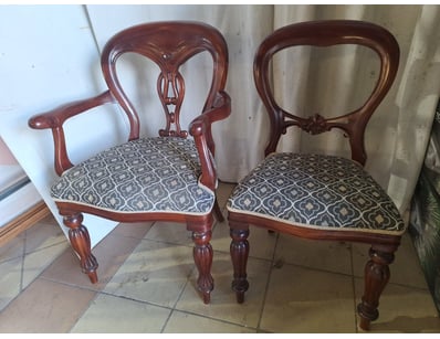Pair of dining chairs featuring timber frames with...