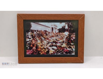 FRAMED IMAGE OF FLORAL TRIBUTES FOLLOWING ELVIS PR...