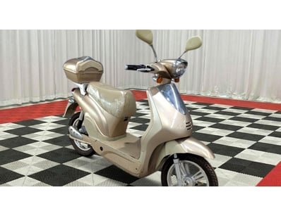 Cream/beige electric scooter featuring retro Vespa...
