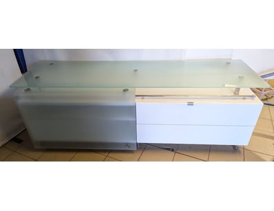 Modern retail display counter featuring a white la...