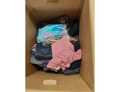 Large cardboard storage box containing mixed cloth...