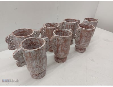 Set of seven ceramic vessels featuring a rustic, w...