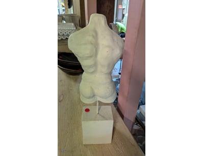 Classical plaster torso sculpture mounted on a cub...