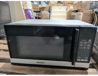 Sharp microwave oven featuring a black and silver ...