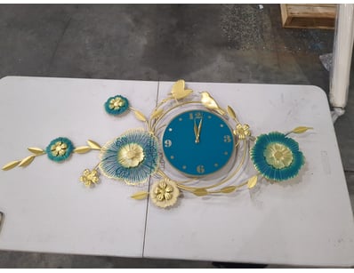 Ornamental wall clock featuring a striking teal bl...