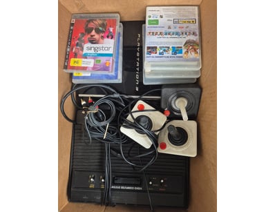 Retro PlayStation 3 gaming bundle featuring a blac...