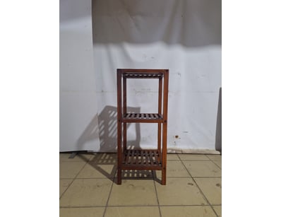 Wooden shelving unit featuring three tiers. Each s...