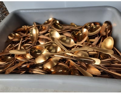 Container of assorted spoons, gold finish.

Unkn...