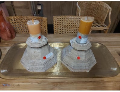 Decorative wooden candleholder set featuring tiere...