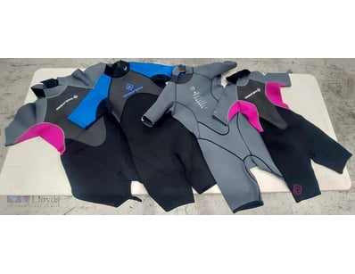 Lot of four wetsuits in various styles and sizes. ...