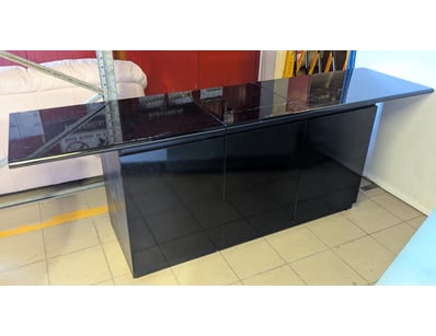 Black cabinet with three-section configuration. Fe...