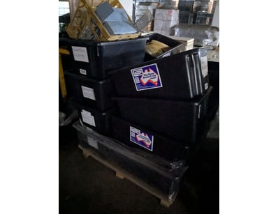 Lot comprising stacked black industrial storage bi...