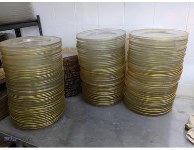 Extensive collection of gold-rimmed glass charger ...