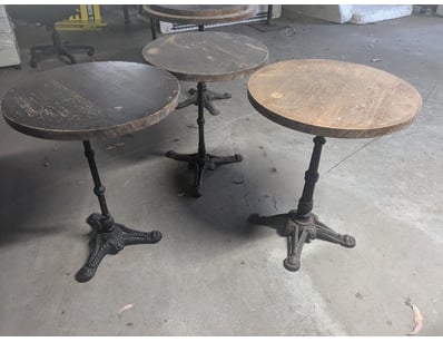 Vintage cast iron pedestal tables featuring ornate...