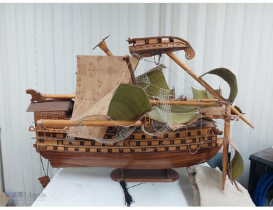 Elaborate wooden model sailing ship featuring a mu...