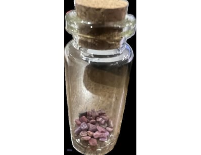 10 CARAT RUBY ROUGH IN GLASS VIAL        

Conditi...