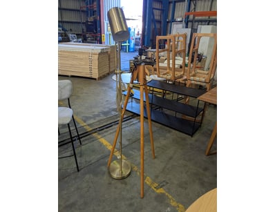 Modern floor lamp featuring a wooden tripod base i...
