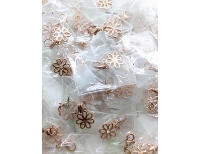 COLLECTION OF ROSE GOLD COLOURED FLOWER CHARMS

To...