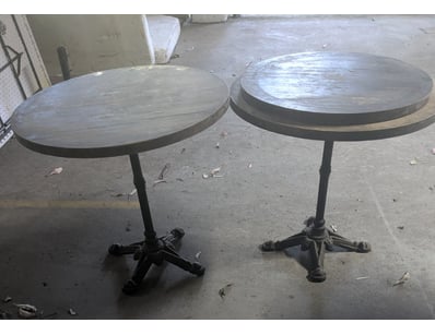 Pair of industrial-style bistro tables featuring r...