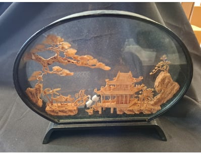 decorative diorama housed in an oval glass display...