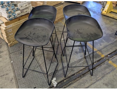 Set of four modern bar stools featuring molded bla...