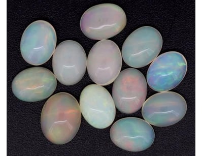 10.67CT TSW X 12 OPALS

Oval Cabochon Cut, Orang...