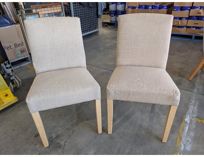 Pair of contemporary dining chairs featuring uphol...