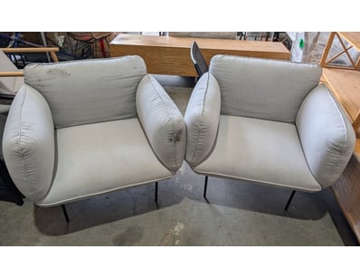 Pair of grey upholstered armchairs featuring disti...