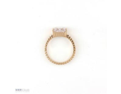 2.51 CT RADIANT EAST-WEST CHANNEL-SET RING IN 18KT...