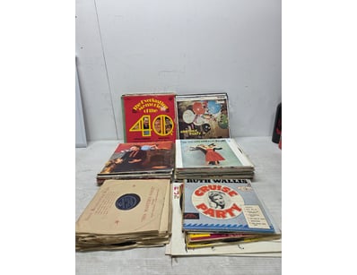 Vinyl records spanning multiple decades, featuring...
