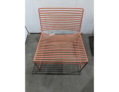 Modern minimalist chair featuring a sleek tubular ...