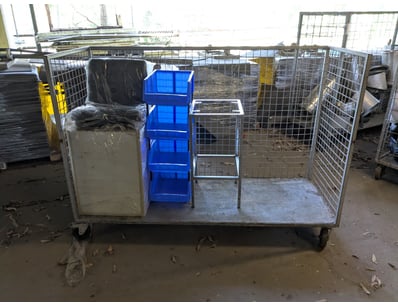 Industrial mobile storage cage system featuring a ...