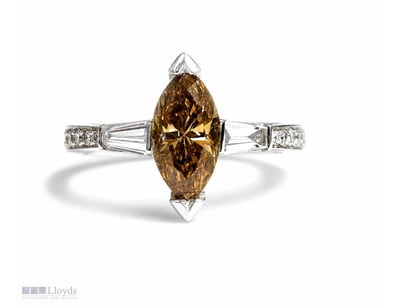 COGNAC AND WHITE DIAMOND RING WITH TAPERING BAGUET...