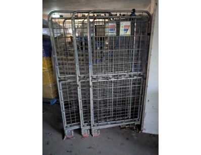 Industrial roll cage trolley system comprising thr...